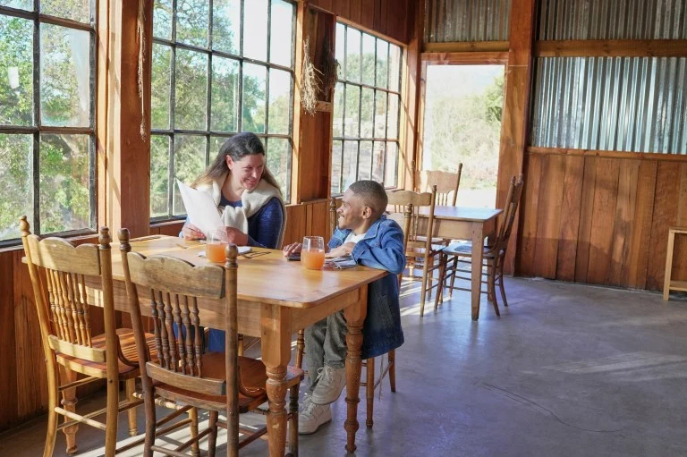Support worker talking happily with disabled man