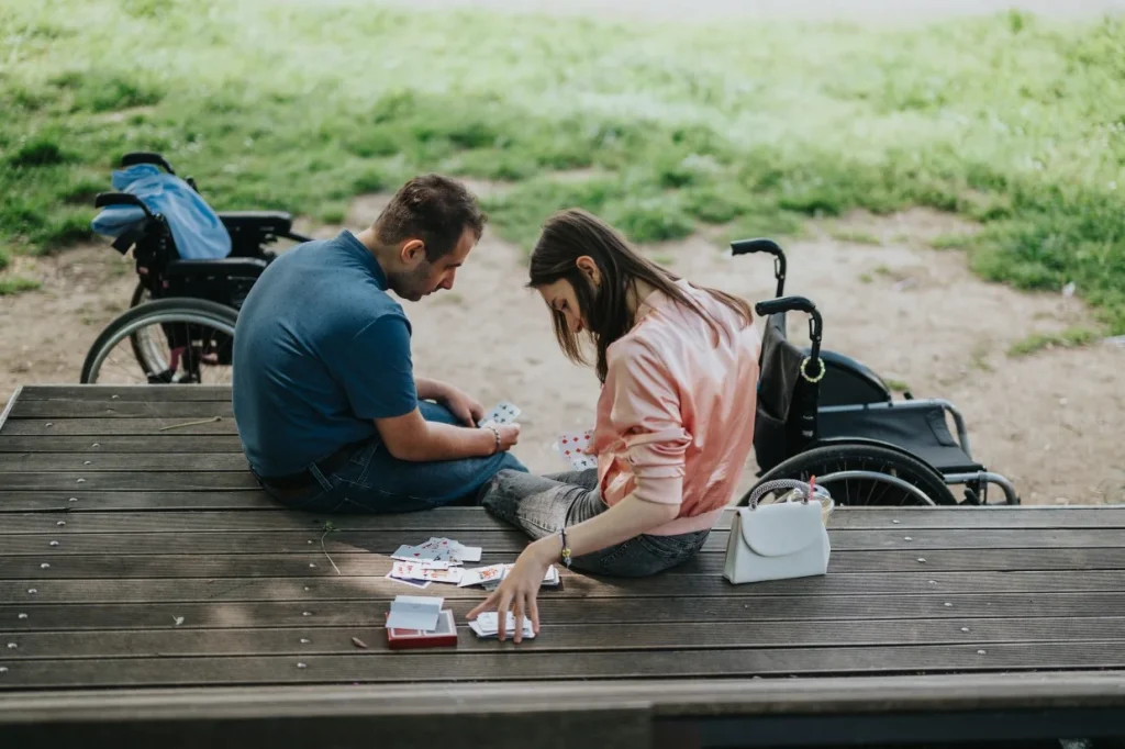 Two disabled friends playing card game